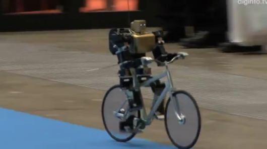 Miniature robot rides bicycle like a pro
