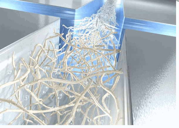 Artist´s impression of the production of ultra-strong cellulose fibres: The cellulose nano fibrils flow through a water channel and become accelerated by the inflow of additional water jets from the sides. The acceleration lets all fibrils align with the direction of flow, finally locking together as a strong fibre. Credit: DESY/Eberhard Reimann
