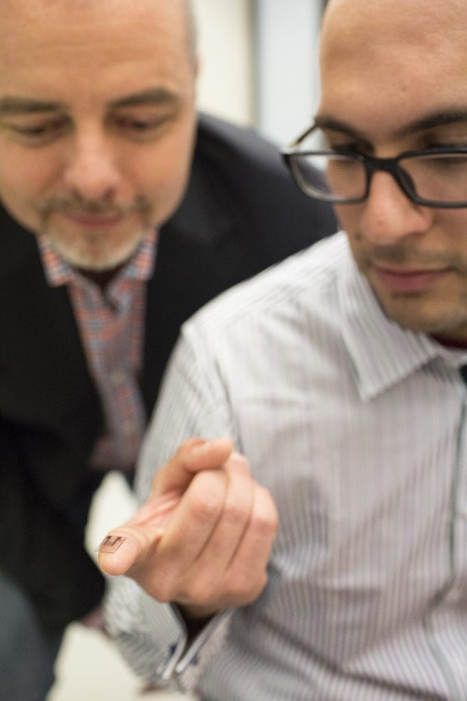 Researchers Professor James Friend and Dr Amgad Rezk with the lithium niobate chip