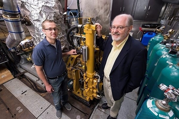Sage Kokjohn, left, and Rolf Reitz check a room with test monitors and air regulators that are connected to an operating, one-cylinder diesel engine in the Caterpillar Engine Lab at the Engineering Research Building. Photo: Jeff Miller