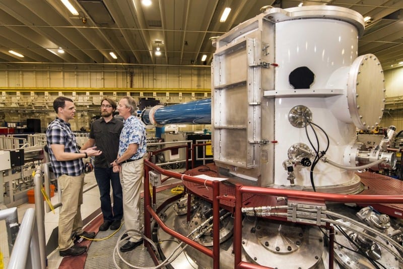 At the heart of Sandia National Laboratories’ Z machine, Matt Gomez, left, presents an idea to Steve Slutz, right, while Adam Sefkow looks on. Credit: Randy Montoya