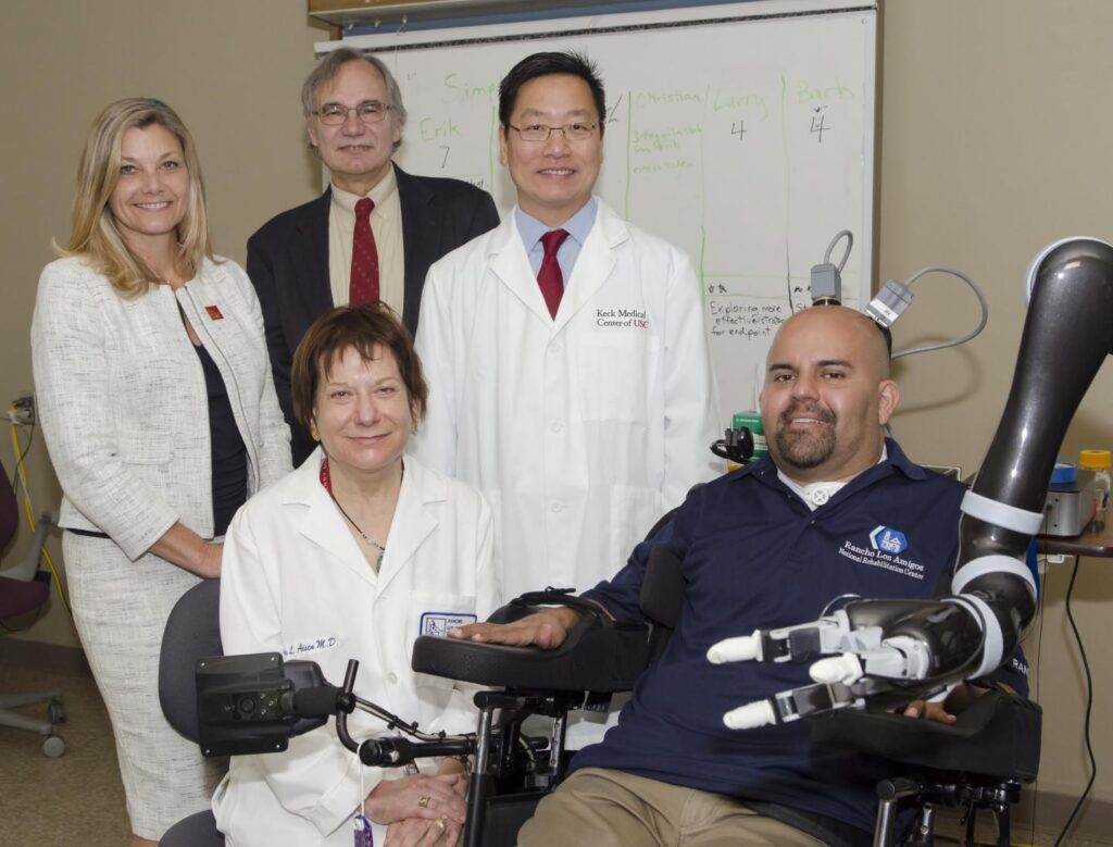 Seated (from left): Dr. Mindy Aisen, chief medical officer at Rancho Los Amigos and patient Erik Sorto. Standing: Dr. Christianne Heck, associate professor of neurology at USC and codirector of the USC Neurorestoration Center; Dr. Richard Andersen, the James G. Boswell Professor of Neuroscience at Caltech; Dr. Charles Y. Liu, professor of neurological surgery, neurology, and biomedical engineering at USC. CREDIT: Lance Hayashida, Caltech