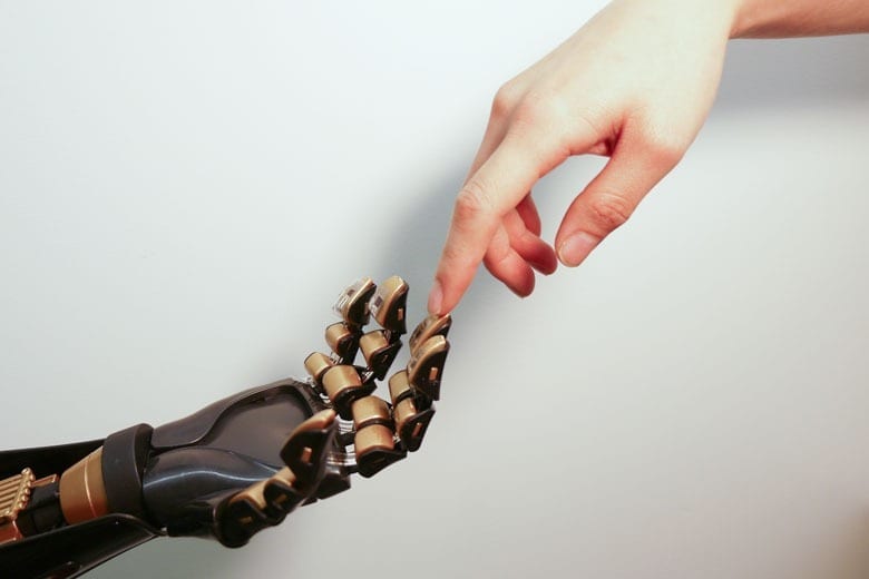 Stanford chemical engineering Professor Zhenan Bao and her team have created a skin-like material that can tell the difference between a soft touch and a firm handshake. The device on the golden ?fingertip? is the skin-like sensor developed by Stanford engineers. (Bao Lab)