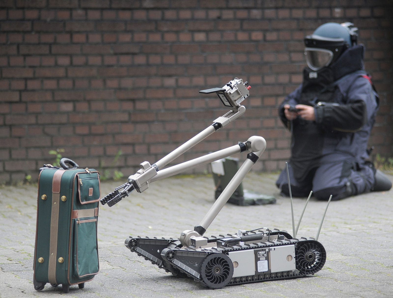 Remote-controlled robot inspects suitcase bombs