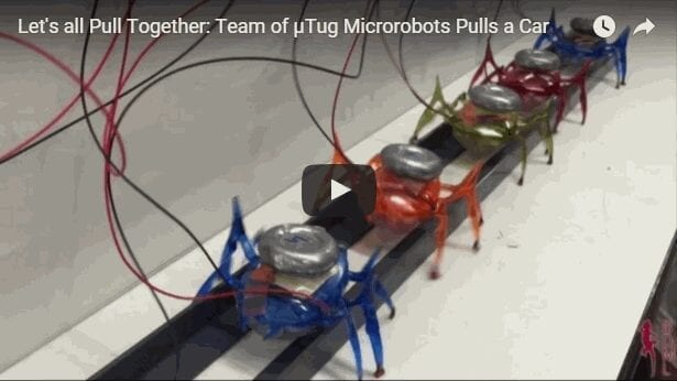 Teams of Tiny Ant-like Robots Can Move a 2-Ton Car