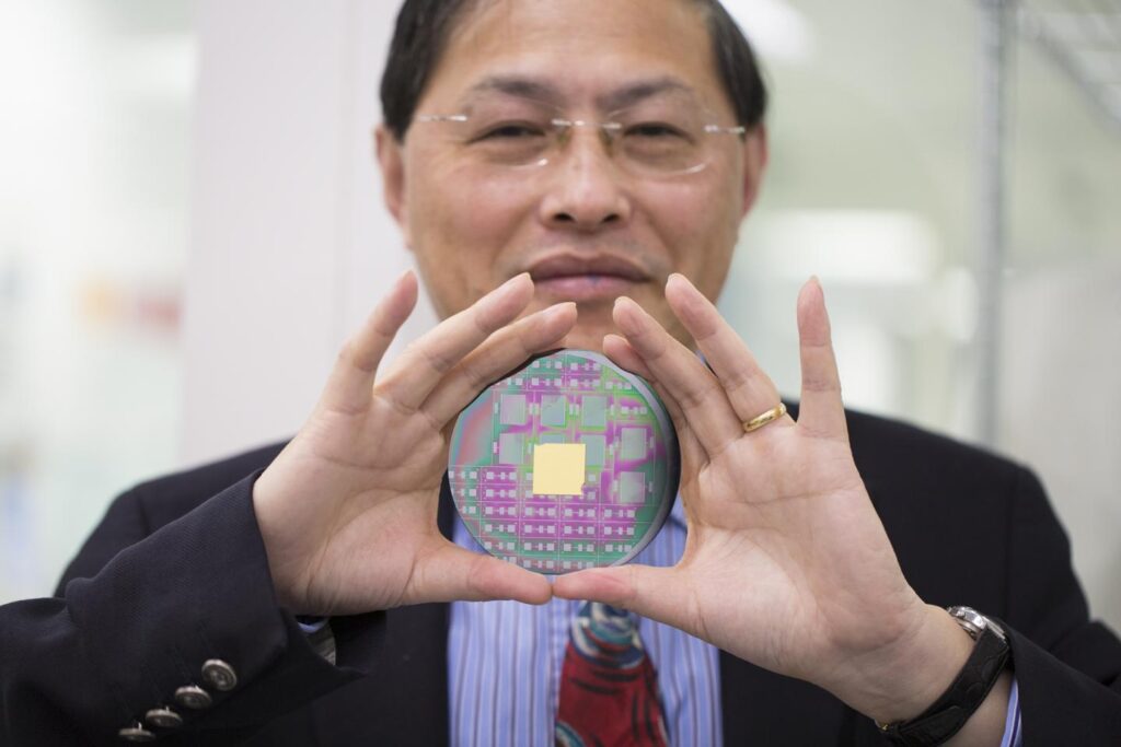 RMIT University's Professor Min Gu with the breakthrough nanophotonic chip that can harness the angular momentum of light. CREDIT RMIT University