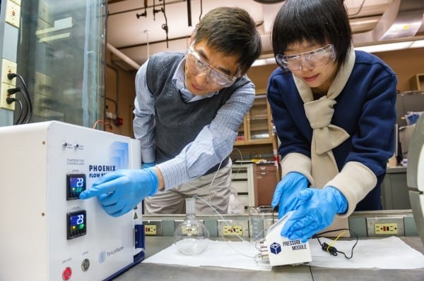 Argonne Principal Chemical Engineer Jie Li, left, and postdoctoral researcher Alina Yan create coated nanoparticles in a continuous flow reactor. Nanoparticles are key to an ongoing effort at Argonne to create more efficient window films.