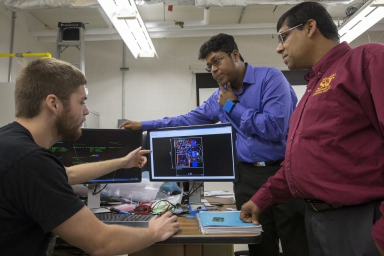 A Missouri S&T team including, from left, graduate student Alec Bayliff, Dr. Debraj De and Dr. Sajal Das, created a wearable device for the wrist that can track a person’s movements, environment, bio-signals and more. De is wearing the device. Photo By Sam O’Keefe/Missouri S&T
