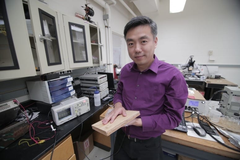 Associate Professor Xudong Wang holds a prototype of the researchers’ energy harvesting technology, which uses wood pulp and harnesses nanofibers. The technology could be incorporated into flooring and convert footsteps on the flooring into usable electricity. PHOTO: STEPHANIE PRECOURT