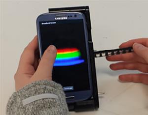 Smartphone linked to a handheld spectral analyzer for diagnostics