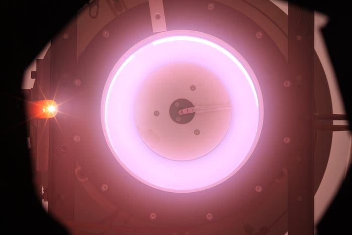 An electric thruster that ingests scarce air molecules from the top of the atmosphere as propellant for low-orbit satellites