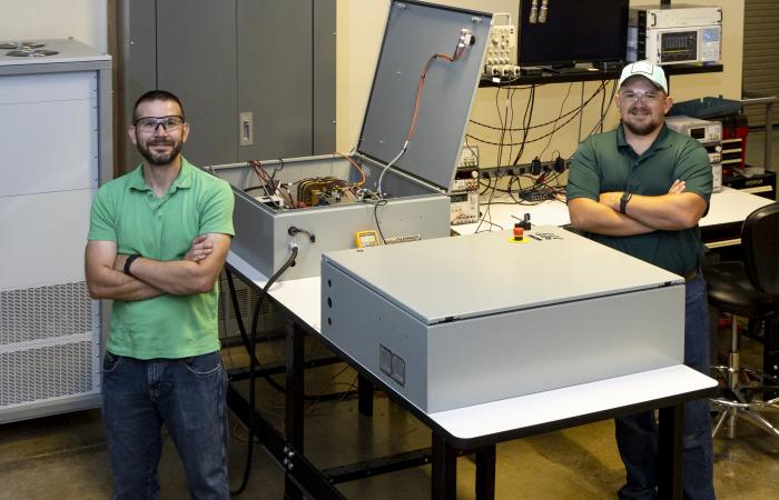 Researchers Steven Campbell (L) and Mitch Smith (R) with the hybrid inverter platform at the ORNL GRID-C development and testing facility. Credit: Carlos Jones, ORNL/U.S. Dept of Energy.