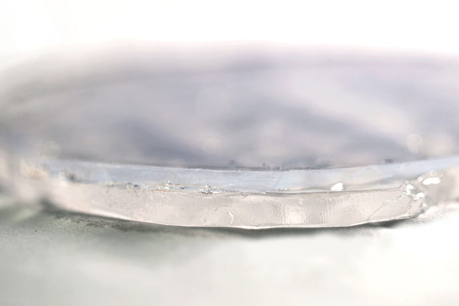 MIT researchers have developed a two-layer passive cooling system, made of hydrogel and aerogel, that can keep foods and pharmaceuticals cool for days without the need for electricity.  In this photo showing a close-up of the two-layer material, the upper layer consists of aerogel and the bottom layer of hydrogel.
Courtesy of the researchers