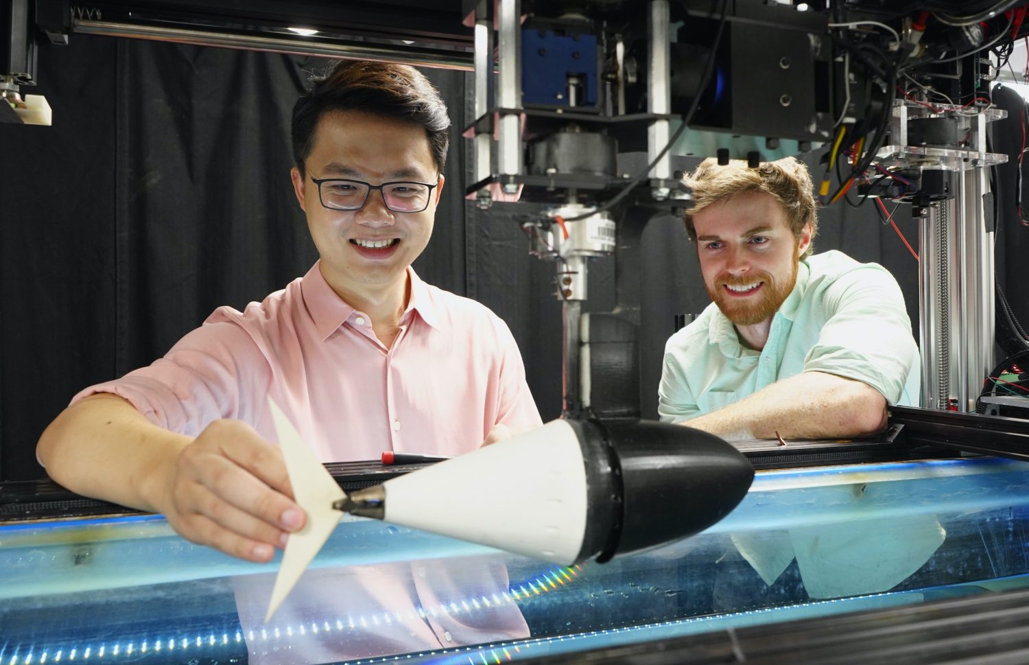 Assistant professor Dan Quinn, right, and postdoctoral researcher Qiang Zhong with the robotic tuna they designed to have a tail with tunable stiffness.