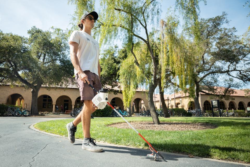 Stanford PhD candidate Michael John Raitor tests out the augmented cane, created with way-finding capabilities similar to those used in autonomous vehicles. | Andrew Brodhead