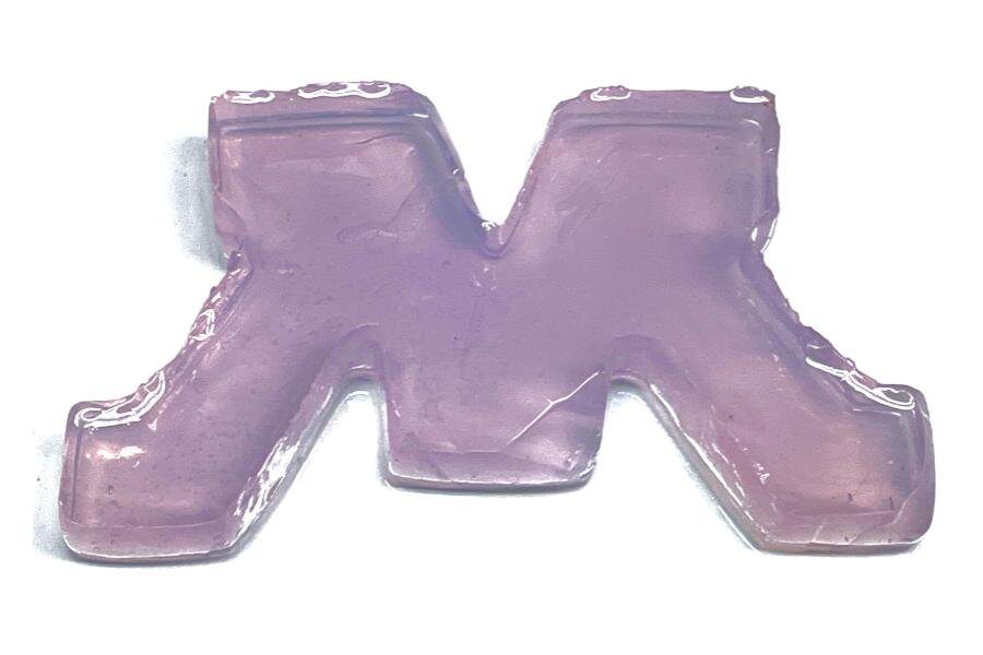 *This is not jello.* This block M is composed of engineered bacteria and silica — a material commonly used in plaster — cross-linking together. The purple tint is a protein produced by the bacteria. If the M was damaged, researchers could add nutrients and any cracks would self-heal. Credit: Dr. Sunyoung Kang, Postdoctoral Associate, Schmidt-Dannert Lab.