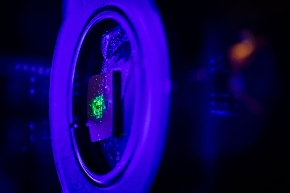 QUANTUM LOOKING GLASS — Green laser light illuminates a metasurface that is a hundred times thinner than paper, which was fabricated at the Center for Integrated Nanotechnologies. CINT is jointly operated by Sandia and Los Alamos national laboratories for the DOE Office of Science. (Photo by Craig Fritz)
