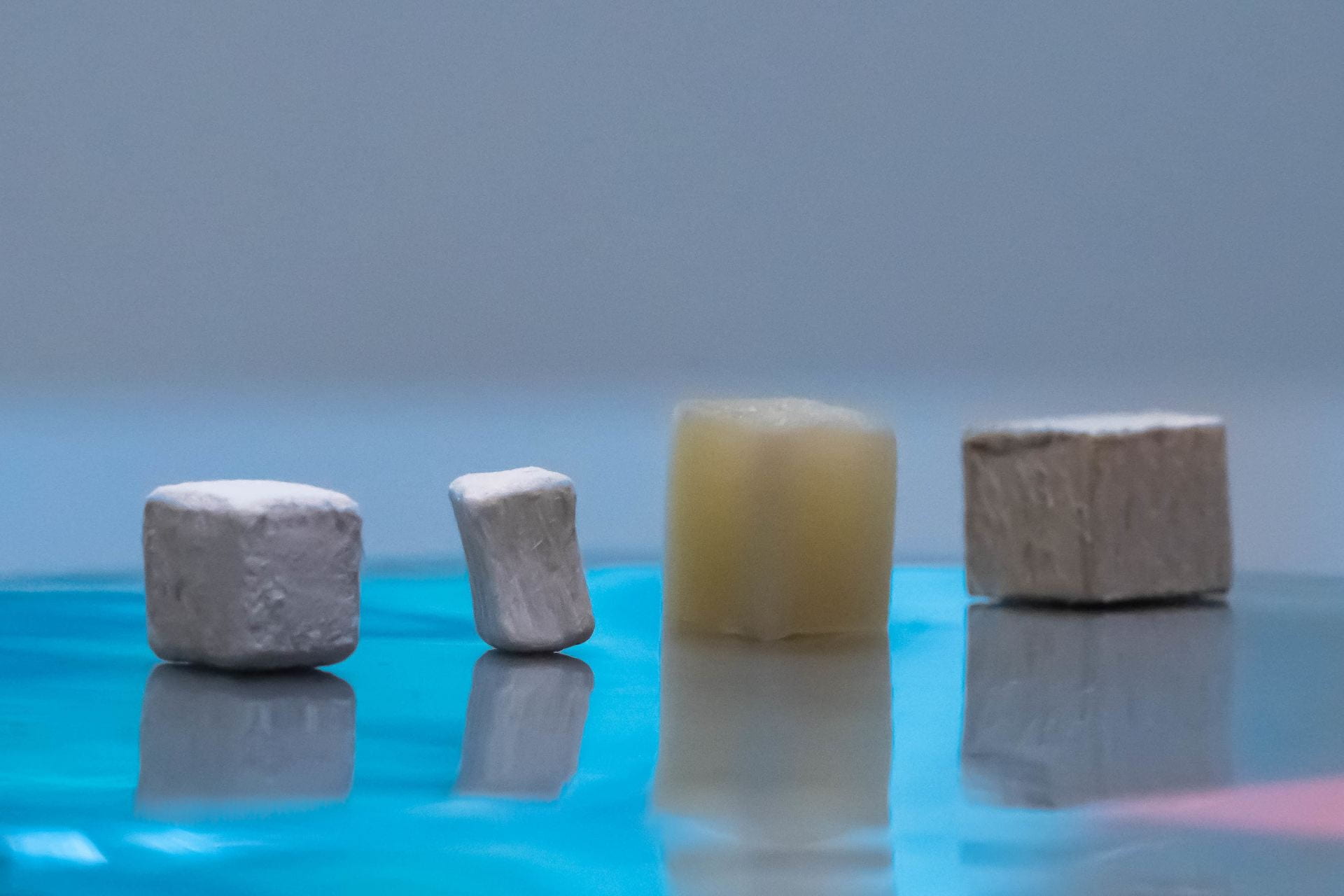 Wood pieces at different stages of modification, from natural (far right) to delignified (second from right) to dried, bleached and delignified (second from left) and MOF-infused functional wood (first on the left). (Photo by Gustavo Raskosky/Rice University)