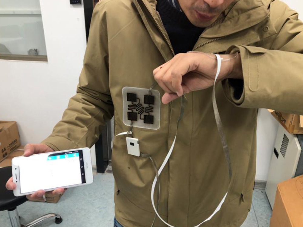 A Penn State-led research team developed a standalone system to monitor nitrogen dioxide in exhaled breath and in the environment. Fabricated from the same nanocomposite material, the self-powered system stretches to adhere to skin or clothes. Credit: Provided by Huanyu "Larry" Cheng/Penn State.