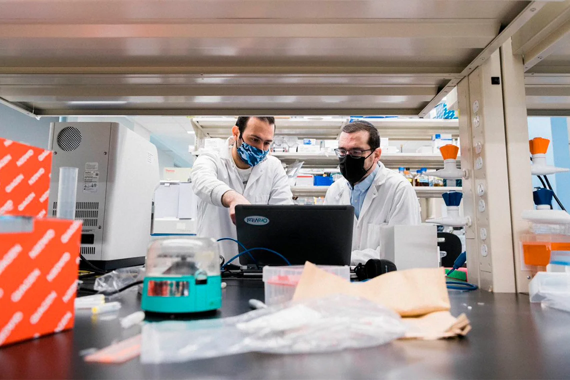 Researchers Michael Glogauer, right, and Abdelahhad Barbour, left, work in a dry area of a lab that's reserved for data analysis (photo by Jeff Comber)